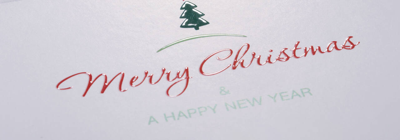 An elegant Christmas card with a decorated tree and the ornate text "Merry Christmas & A Happy New Year."