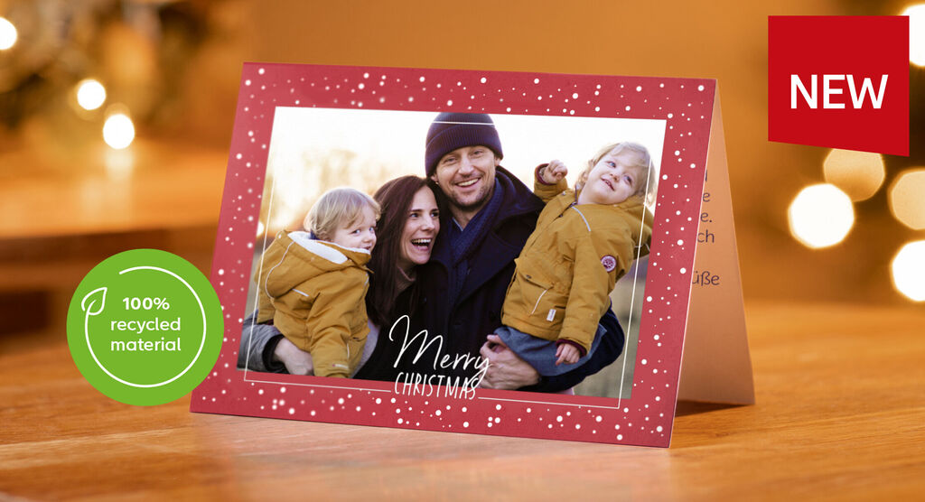 A festive Christmas card shows a happy family outdoors, surrounded by sparkling lights and festive mood.
